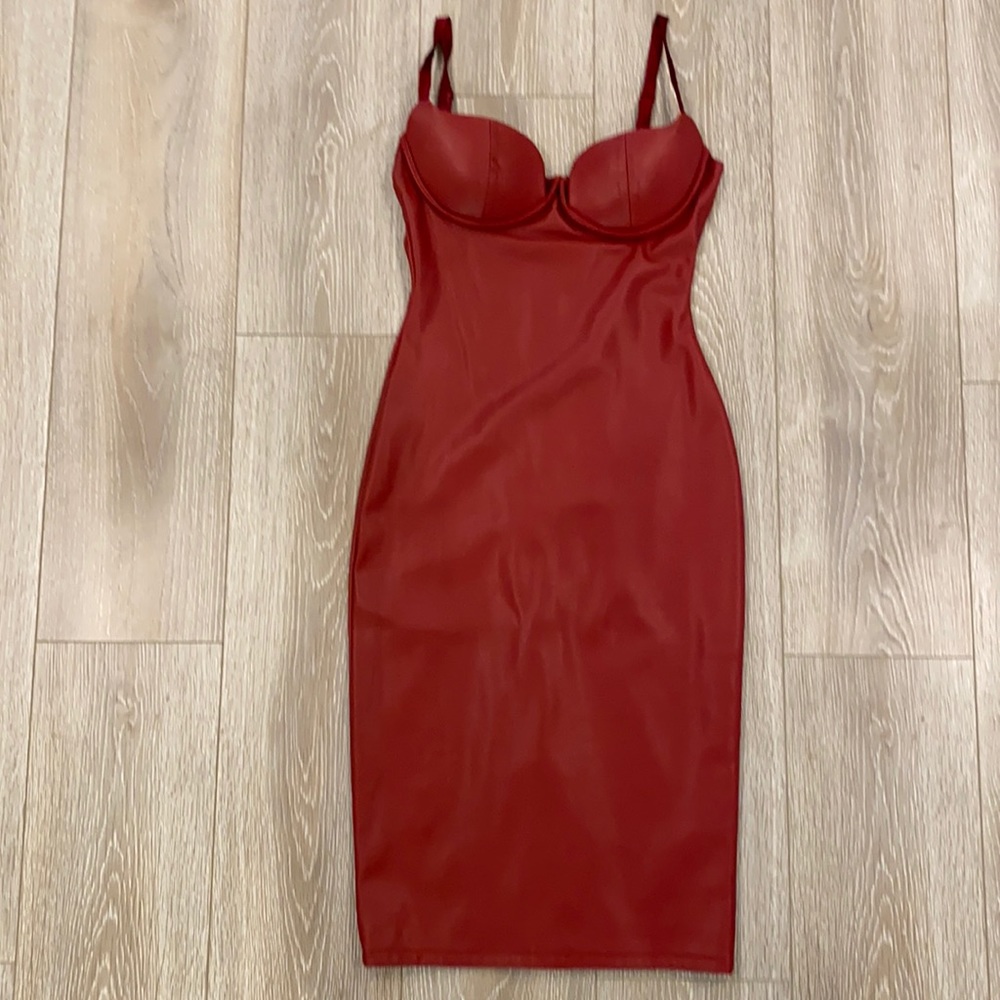 Red leather dress with straps and padded bust.